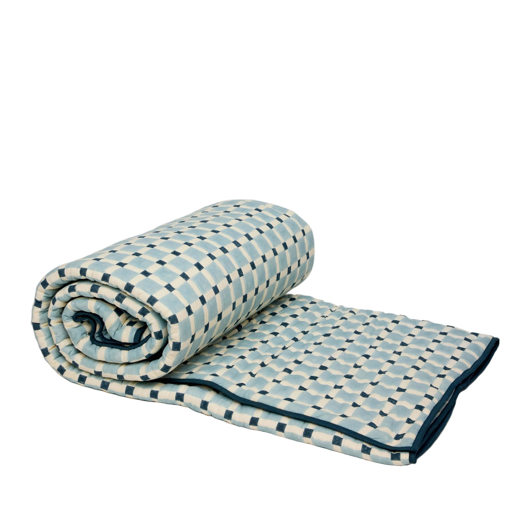 Rolled-up quilt with geometric pattern