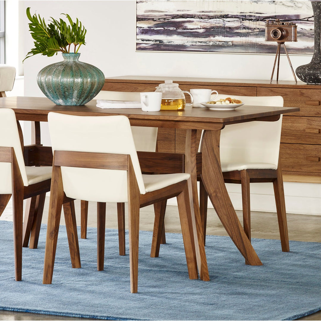 Dining room with wooden table and chairs on a blue rug