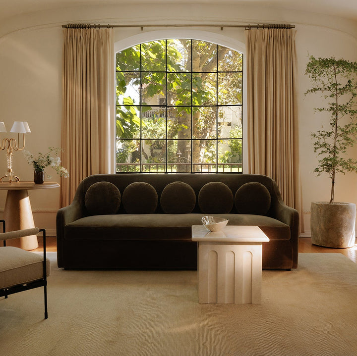 Living room with a dark green mohair sofa, armchair, and coffee table.