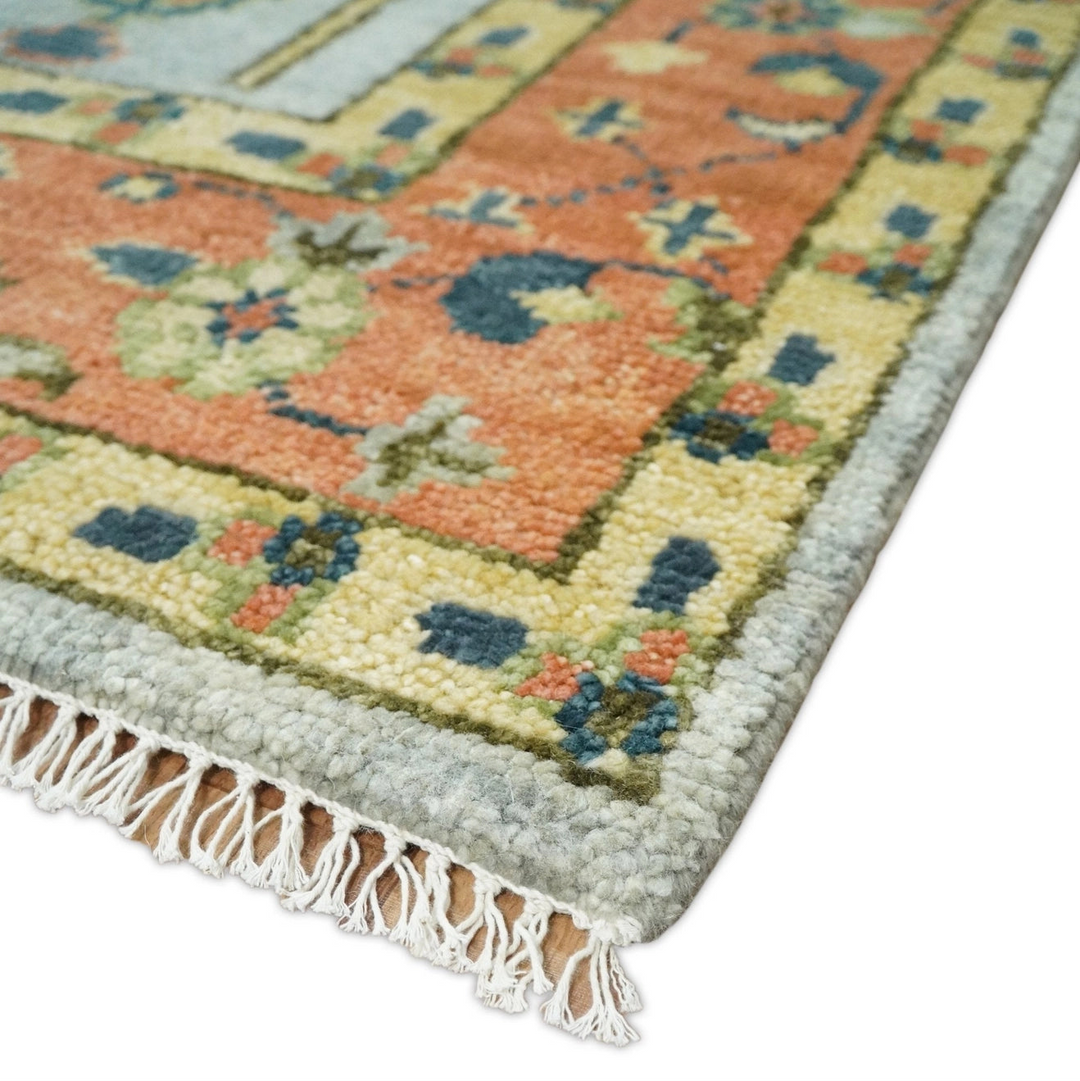 Close-up of a colourful patterned rug with tassels on a white background